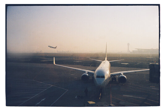 Early morning view of airport runway with planes 