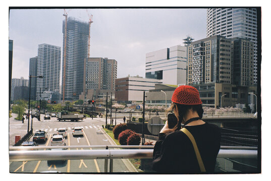 Cityscape view with a person taking pictures in a modern urban setting