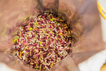Close up of pistachios inside a plastic bag during packaging process