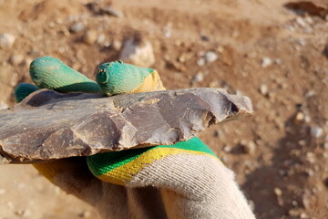 Stone similar to a large flint axe used in the Stone Age, field photo at a quarry