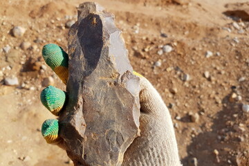 Stone similar to a large flint axe used in the Stone Age, field photo at a quarry