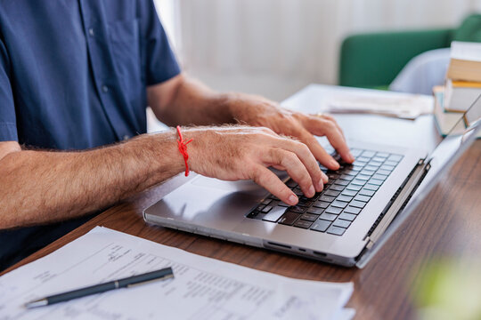 Hands of a man Typing on Laptop Keyboard