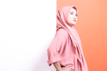 Contemplative gaze of woman wearing traditional hijab, against a