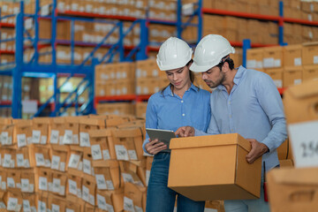 Warehouse worker working in warehouse storage. Foreman or worker work at factory site check up...