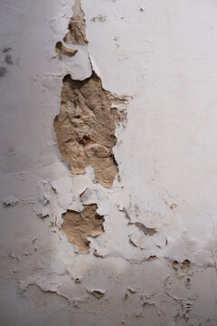 Peeling paint on a white wall.