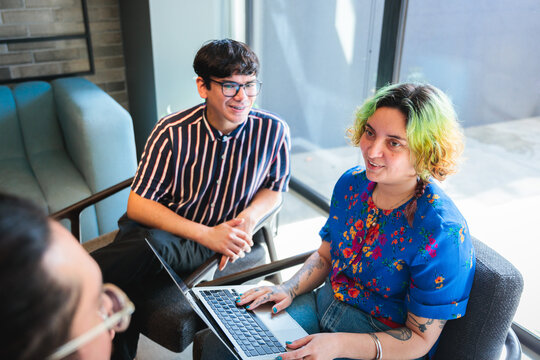 Young woman leading work with startup team