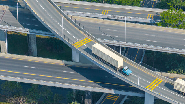 The container truck is on the highway.