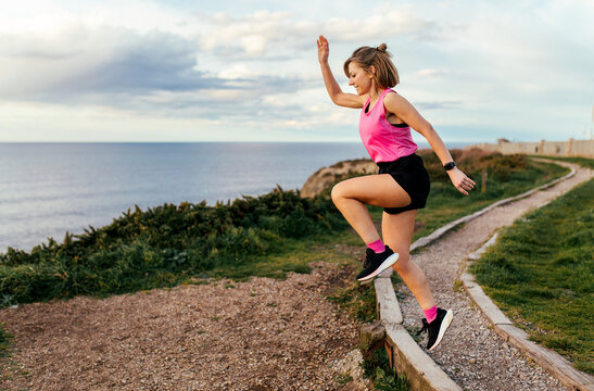 Sporty woman jumping outdoors
