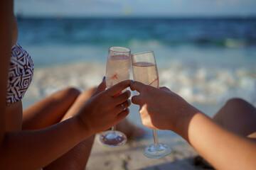 Two glasses of champagne in the hands of a newlywed.