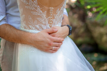 Bride and groom hugging romantically and tenderly back view