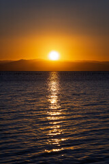 Serene Sunset Over Calm Waters: A Symphony of Colors Reflecting Tranquility