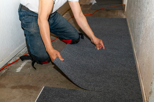 worker installing carpet