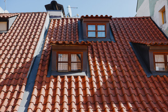Red tiled rooftop with dormer windows in Prague