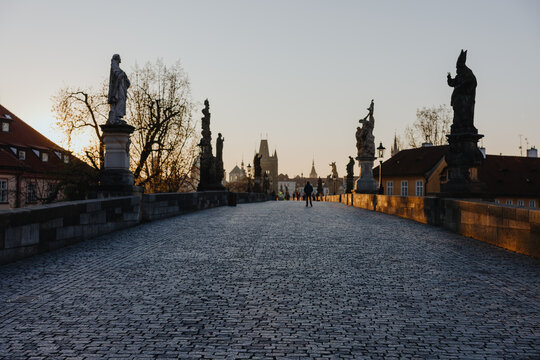 Charles Bridge at Sunrise with Statues and Silhouettes