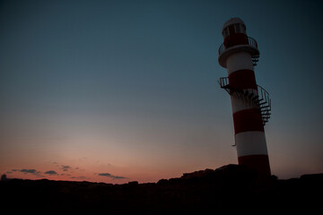 Lighthouse at sunset overlooking the Caribbean sea and sky in Mexico