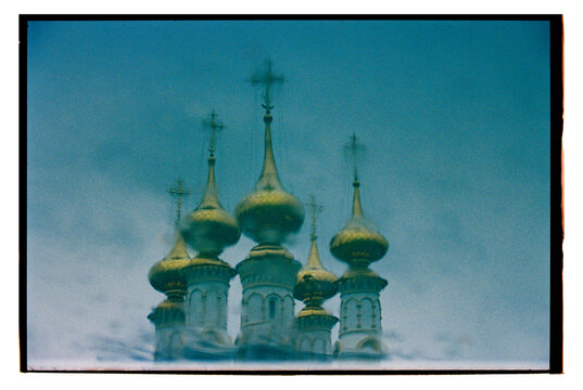 Reflections of golden domes in tranquil water