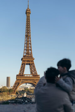 ender father-son embrace with stunning Eiffel Tower view