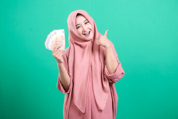 Successful asian woman displays euros, symbolising prosperity an
