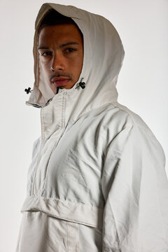 Model wears oversized white hooded jacket in studio setting