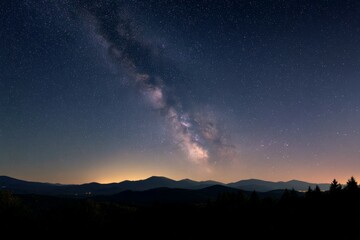 Fototapeta premium Stunning night sky with milky way over mountain range and forest
