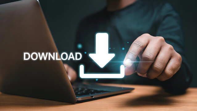 A digital download concept shows a hand using a laptop for downloading process, the future of data exchange with modern technology and internet connectivity.