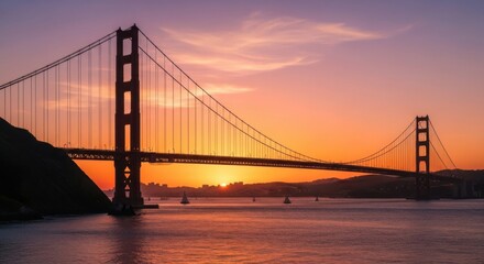 Fototapeta premium Iconic Golden Gate Bridge at Sunset Silhouette with Vibrant Orange Sky and Calm Water Reflection