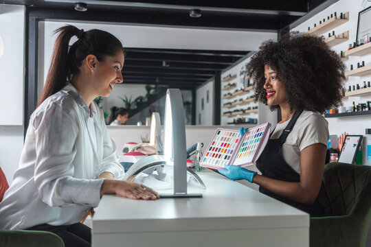 Nail Technician Presenting Color Options to a Customer