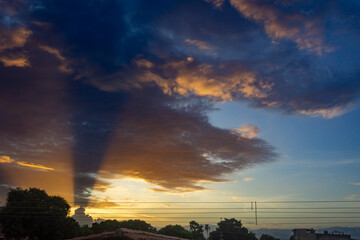 Sunset sky with clouds and rays of light in the evening.