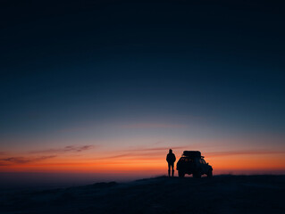 Fototapeta premium silhouette of person and small vehicle at arctic sunset