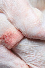 Texture of raw chicken pieces. Closeup. Vertical shot