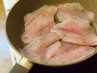 The texture of raw fish pieces sprinkled with pepper. Closeup