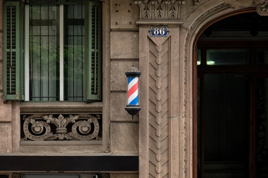 Rotating Barber Pole in Front of Modernist Building
