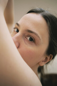Close-up portrait of a woman revealing her natural beauty