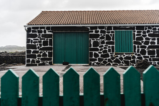 Lava stone house with green doors on Pico Island