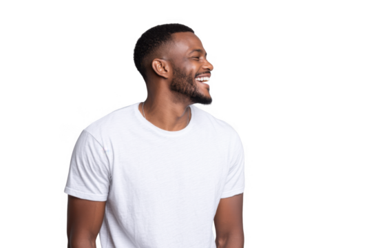 A joyful young man with a beard and short hair. wearing a plain white t-shirt. smiling against a light gray background. capturing a moment of happiness and positivity