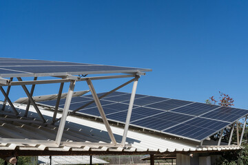 Shared solar panel system across rooftops in rural neighborhood