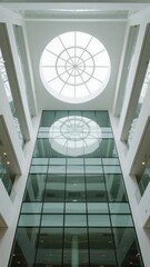 Obraz premium Modern building atrium with glass ceiling and circular skylight