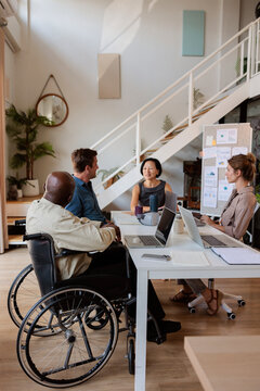 Diverse team meeting at a modern office table.