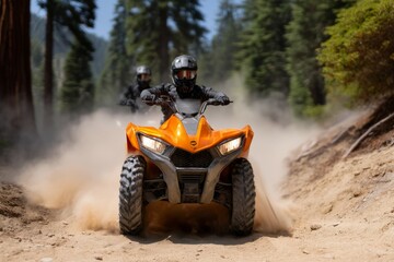 Two adults on atvs riding through forest trail kicking up dust