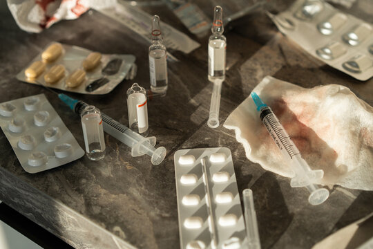Medical Supplies with Syringes and Tablets on Table