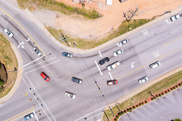 Aerial view of multi lane road intersection with multiple vehicles traveling in different...