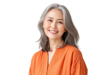 A smiling mature woman with gray hair wearing an orange blouse. set against a clean white background. exuding confidence and warmth. ideal for wellness and lifestyle themes