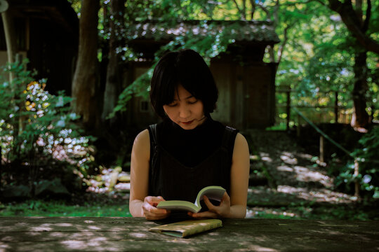 A serene woman immersed in a book.