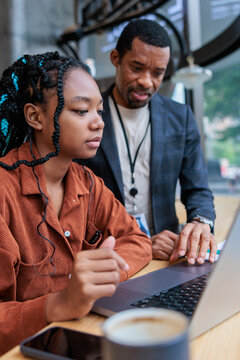 Boss comes over to help new intern