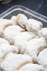 Close up macro shot of Indonesian snow cookies (kue putri salju) inside a plastic jar