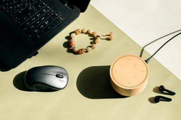 Wireless beige smart speaker on working table at home.