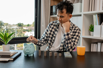 he is saving money for his future plans, putting some if his income in a piggy bank, he is saving...