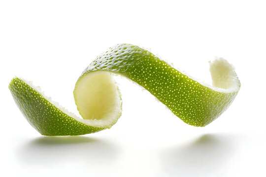 Fresh lime peel twirls gracefully against a clean white backdrop, showcasing vibrant green hues and a delicate spiral shape, perfect for culinary designs.