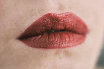 Close-up of full lips with bold red lipstick 
