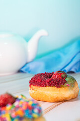 Mini donuts with chocolate and strawberry toppings, captured in a low angle macro shot